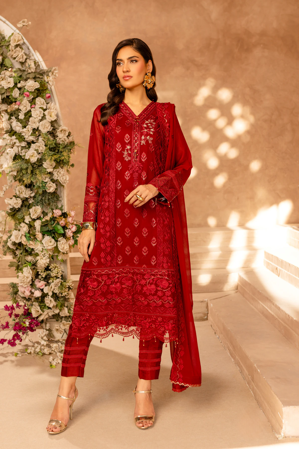 Woman wearing an embroidered red lawn suit