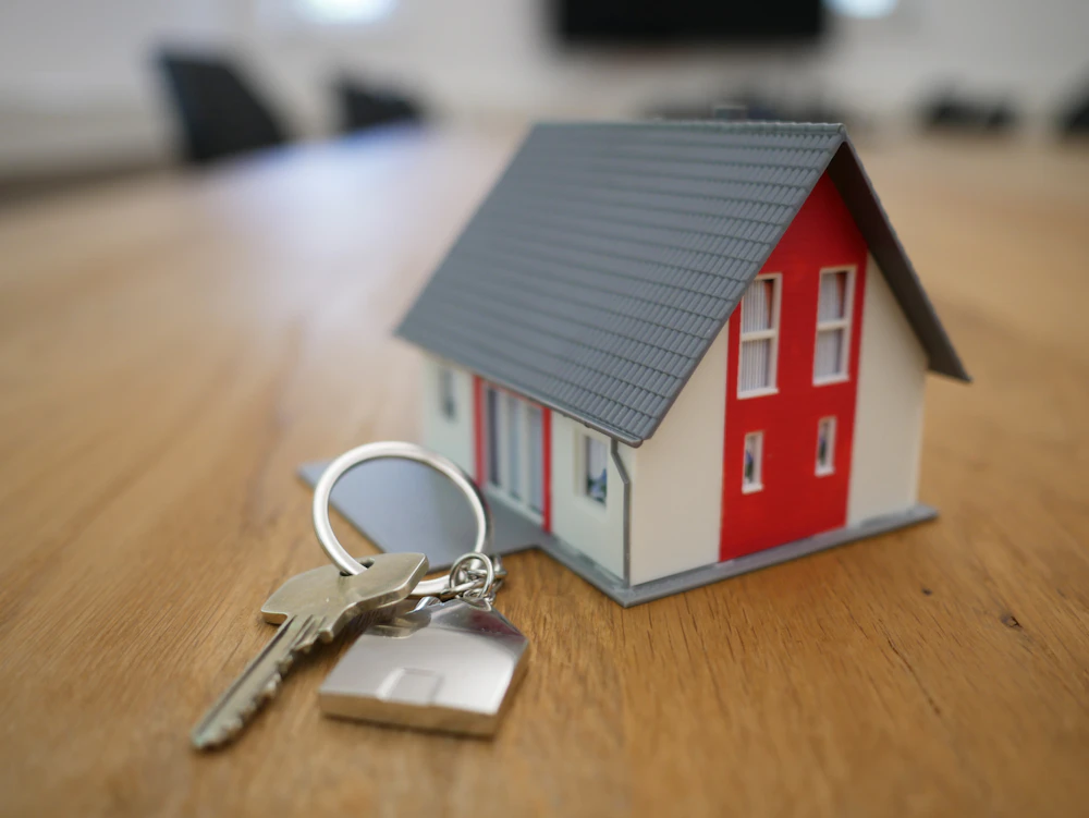 A model house with keys on a table