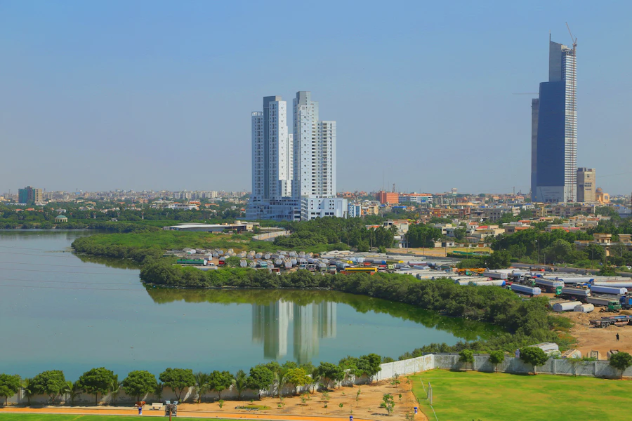 High-rise apartment towers beside a lake in Karachi